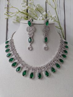 The perfect hand crafted jewelry is sure to compliment your bridal and party outfit this season!  A GORGEOUS fushion of elegance and style - this unique set designed with Emerald green stones and american diamond details is sure to be ADORED for years to come. Full set comes with earrings and is finished with a silver base. **ON TREND AND CHIC ** Adorn yourself in this LIGHT WEIGHT and easy to wear design - pairs well with modern looks! Lovely BRIDAL set for your big day and Pre-Events (Sangeet, Teardrop Jewelry With Intricate Design For Party, Teardrop Party Jewelry With Intricate Design, Festive Green Jewelry For Anniversary, Teardrop Jewelry With Intricate Design For Wedding, Teardrop Wedding Jewelry With Intricate Design, Elegant Green Bridal Sets For Parties, Silver Bridal Sets For Diwali, Traditional Teardrop Jewelry With Elegant Design, Festive Green Jewelry Sets With Elegant Design