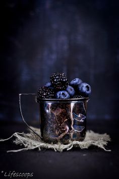 blueberries and blackberries in a metal cup