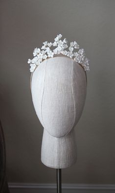 EMMA Porcelain Blossom and Pearl Tiara WHAT WE LOVE: The Emma Tiara needs no additional sparkle to create a swoon worthy romantic aesthetic. The delicate white porcelain blossoms are handmade and hand wired with faux pearl accented centers set atop a comfortable flexible headband. Available in Rose Gold or Silver. DETAILS: White Porcelain Blossoms with creamy faux pearl accents accented centers. Set upon a wire headband with bobby pin loops on the ends for a secure hold in your tresses. Height - Bridal Headbands, Pretty Furniture, Floral Tiara, Romantic Aesthetic, Fav Food, Pearl Tiara, Beautiful Tiaras, Wire Headband, Diamond Tiara