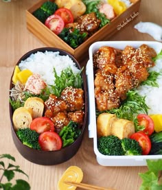 two bento boxes filled with different types of food on top of a wooden table