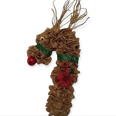 a christmas decoration made out of burlocked fabric with a red ornament hanging from it's side