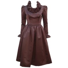 Jill Richards, the California designer of this fabulous 1970's cocktail dress, had the well earned nickname of 'Ruffles Richards' with both a flair for drama and flattering silhouettes. The dress is fabricated from a rich chocolate brown satin fabric which is expertly cut to provide a fitted torso yielding to a voluminous skirt featuring hidden side pockets (love a hidden pockets in cocktail wear!). The lovely sleeves provide a gentle pouff at the shoulder with a skinny fit to the ruffled cuff. 1970 Dress, Cocktail Wear, Designer Evening Dresses, Brown Satin, California Design, Ruffled Collar, Ruffle Collar, Collar And Cuff, Satin Fabric