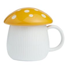 a white and yellow mushroom shaped coffee mug