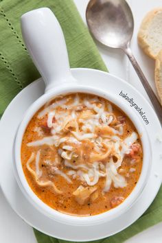 a white bowl filled with pasta and meat soup