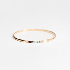 The Stacked Birthstone is a unique style customized to your story. Choose 3-6 natural gemstones in a secure and stunning prong setting on a solid 14k gold bangle. A 3x2mm solid 14k half-round bangle with 3-6 shared prong set natural gemstones.To find your perfect fit, please order our set of sizing bangles first. Gemst 14k Gold Stackable Bangle Fine Jewelry, Stackable 14k Gold Fine Jewelry Bangle, Stackable 14k Gold Bangle Fine Jewelry, Stackable 14k Gold Bangle In Fine Jewelry Style, Minimalist Birthstone Bangle Jewelry, 14k Gold Gemstone Bangle, 14k Gold Bangle With Gemstone, 14k Yellow Gold Gemstone Bangle, 14k Gold Gemstone Bangle Fine Jewelry