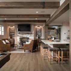 a living room filled with furniture and a fire place next to a kitchen counter top