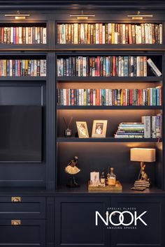 a bookshelf filled with lots of books next to a lamp and a television