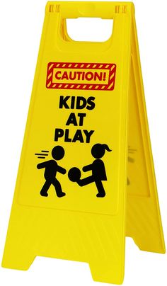 a yellow caution sign that says kids at play on the front and back of it