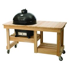 an outdoor bbq on wheels with a wooden table