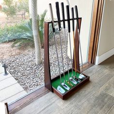 a wooden stand with golf clubs in it and the words premium wood stained finish makes a great gift for golfers