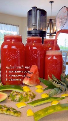 there are three jars with watermelon on the table