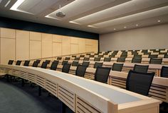 an empty lecture hall with black and white checkerboard seats on the front row