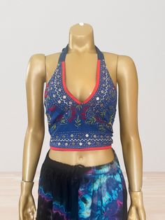 This vibrant, hand-embroidered bikini halter top offers stylish Boho-inspired fashion with its colorful threads and sequin embellishments. Paired with jeans or a skirt, this is the perfect summer top to stand out in and make a statement. The lining is a contrasting color to give it a unique, eye-catching look. One Size Made in India Care Instructions: Dry clean only Girl In The Mirror, Colorful Threads, Upcycle Design, Design Clothes, Inspired Fashion, The Mirror, Summer Top, Perfect Summer, Halter Top