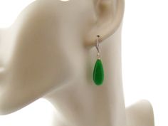 "Long green earrings: Graceful long jade green quartz teardrop gemstones dangle from cubic zirconia studded rhodium plated brass ear wires. Beautifully understated classical earrings for the woman with discerning taste. Length: 1.75 inches from the top of the ear wire Arrives with a Marty White card in a lovely decorative bag and bubble wrap packaging. Facebook: http://www.facebook.com/mwhitejewelry ** Please \"Favorite\" my shop and come back often! Thanks for buying hand-made...2018-29" Elegant Jade Teardrop Earrings, Green Jade Teardrop Pendant Jewelry, Nickel-free Teardrop Jade Earrings, Vintage Green Jade Earrings, Hand-strung Green Jade Jewelry, Locket Bracelet, Cameo Ring, Jade Earrings, Cameo Jewelry