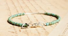 This cute dainty bracelet is handmade with opaque turquoise Picasso Japanese seed beads, sterling silver curved tube bead, and sterling silver findings (the heart charm is silver plated). The bracelet fastens with sterling silver lobster clasp. You can choose the length of your bracelet before putting it in the cart. More bracelets - https://www.etsy.com/shop/SentimentoShop?section_id=13605661&ref=shopsection_leftnav_2 Please contact me if you have any questions. Thank you for looking and have a great day! Please note: actual color shade may vary from picture due to computer settings. Turquoise Sterling Silver Beaded Bracelets, Sterling Silver Bohemian Beaded Bracelet, Turquoise Sterling Silver Jewelry With Tiny Beads, Bohemian Sterling Silver Beaded Bracelet With Tiny Beads, Elegant Turquoise Sterling Silver Beaded Bracelets, Bohemian Sterling Silver Beaded Bracelet For Everyday, Minimalist Turquoise Beaded Bracelets, Minimalist Beaded Turquoise Bracelet, Minimalist Turquoise Beaded Bracelet