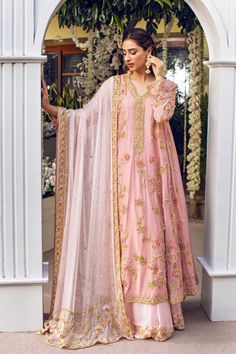 Turn heads in Bano Zargul. A dreamy flowing kalidaar cut from the softest pure cotton net in teapink, hand embellished with pearls, kora, dabka, Swarovski crystals, resham thread work with Agha Noor's signature 3D petals.The kalidaar is layered over a floor length skirt in a contrasting pastel pink hue with a zardosi h Floral Anarkali, Pink Anarkali, Desi Wedding Dresses, Latest Bridal Dresses, Pakistani Wedding Outfits, Pure Chiffon, Sleeves Designs For Dresses, Embroidery Suits Design, Floor Length Skirt