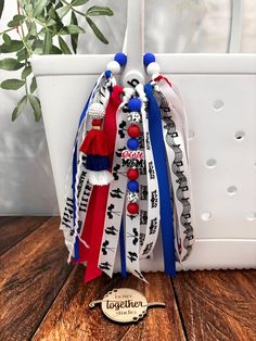 a white bag with red, white and blue ribbons hanging from it