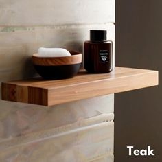 a wooden shelf next to a bowl and soap dispenser