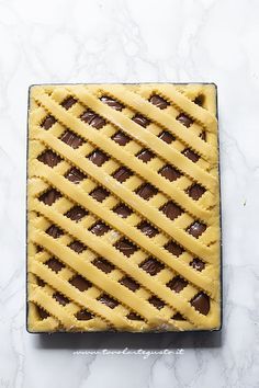 an image of a pie with chocolate on it sitting on a marble countertop in front of a white background