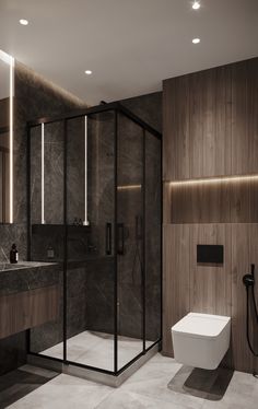 a modern bathroom with dark marble walls and flooring, including a walk in shower