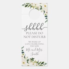 a white door hanger with flowers and greenery on the bottom that says she please do not disturb we were celebrating the new mr and mrs smith