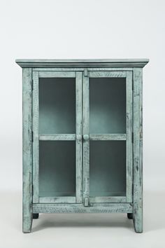 an old green cabinet with glass doors