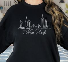 "New York Crewneck, NYC Embroidered Sweatshirt, New York Pullover for him, Handmade New York City Design, Adult Unisex Trendy nyc sweatshirt HOW TO ORDER 1. Select the shirt \"Style and Size\" 2.Select the shirt Color 3. Enter what would you like to say on your t shirt and LETTERING color 4.Select the quantity. 5. Click Add to cart.       If you have any difficulties, send us a message. Processing Time and Shipping The standard processing time is 1-3 business days. We usually proses and ship out the orders the next business day.   USA Orders: Standard : Takes 3 to 5 days to get delivered Priority : Takes 2 to 4 days to get delivered Express: Takes 1 to 2 days to get delivered   METERIALES High Quality Heat Transfer Vinyl, Unisex Shirt DESCRIPTION Please see the sizing chart for choosing yo Nyc Shirt, New York Sweatshirt, New York T Shirt, City Design, Embroidered Sweatshirts, Unisex Shirt, Cute Shirts, Shirt Style, New York City