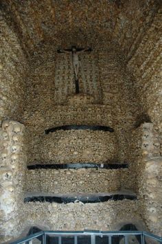 the interior of an old stone building with a crucifix above it