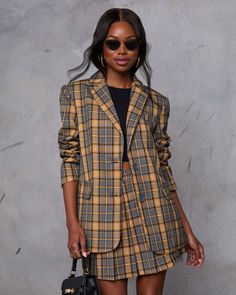 Meet your new fall favorite: the Siena Plaid Blazer. Crafted from sleek suiting fabric, this blazer features a polished front button closure and a chic collar for an effortlessly sophisticated look. Perfectly tailored for a flattering fit, it’s an ideal match for the pleated mini skirt (sold separately) for a coordinated ensemble that transitions seamlessly from day to night. Runs large, consider sizing down Suiting fabric Front button closure Buttoned cuffs Lined Shell: 68% Polyester 32% Rayon Business Blazer With Lapel Collar For Fall, Semi-formal Fall Button-up Suits, Fall Office Suits With Hidden Button Closure, Fall Suit With Welt Pockets, Tailored Fall Blazer For Business, Tailored Fall Business Blazer, Fall Suits With Welt Pockets And Suit Collar, Fall Single-breasted Suits, Fall Single Breasted Suits With Suit Collar