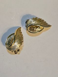 LISNER clip on earrings with gold toned beautiful winged design. Classic. Gold Clip-on Earrings For Anniversary, Elegant Metal Wing-shaped Earrings, Gold-tone Clip-on Earrings For Anniversary, Elegant Wing-shaped Metal Earrings, Gold Metal Clip-on Earrings For Formal Occasions, Gold Costume Jewelry Earrings For Anniversary, Vintage Gold Clip-on Hoop Earrings, Gold Clip-on Costume Jewelry Earrings, Gold Metal Clip-on Earrings For Anniversary