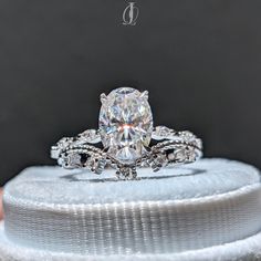 a close up of a diamond ring on top of a box