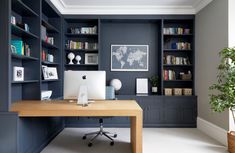 a home office with built in bookshelves and desk