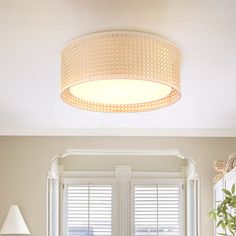 a living room filled with furniture and a round light fixture