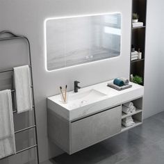 a bathroom with a sink, mirror and towel rack in it's center area