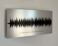 a metal wall hanging on the side of a wall with sound waves painted on it