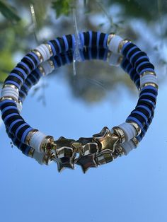 This is a blue, black, gold, and white clay bead bracelet with 3 star charms. Clay Bead Bracelet Ideas, Bead Bracelet Ideas, Make Clay Beads, Clay Bead Necklace, Beaded Braclets, Preppy Bracelets, Homemade Bracelets, Clay Bead Bracelet, Preppy Jewelry