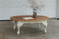 a table with a book and vase on it in front of a white garage door