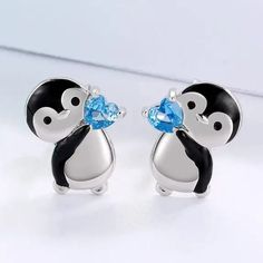 Please Look At Both Pics. The First Pic Has Been Touched Up For Clarity (Penguin Is Black And Silver, Not Black And White) Add A Touch Of Cuteness To Your Outfit With These Little Penguin Holding Blue Heart Stud Earrings. These Earrings Feature A Black And Silver Penguin Holding A Blue Heart, Perfect For Any Occasion. The Earrings Are Made Of Zinc Alloy And Have Silicone Push Back Closures, Ensuring They Stay Secure On Your Lobes. At Approximately 0.5 Inch From Top To Bottom, These Earrings Are Blue Heart Earrings, Penguin Jewelry, Club Earrings, Baublebar Earrings, Cute Penguin, 18k Gold Earrings, Heart Crystal, Mini Hoop Earrings, Teardrop Dangle Earrings