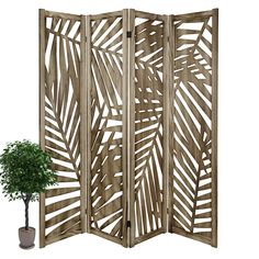 a wooden room divider next to a potted plant