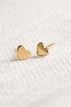 Tiny Gold Heart Stud Earrings - 4mm by Wild Moonstone | Jewelry with purpose | based in Northern California | making Jewelry for you and the people you love. Absolutely adorable, comfortable and solid gold. They are perfect for anyone that loves dainty studs. Shop the collection! stud earrings, heart stud earrings, gold heart stud earrings, gold jewelry, mini stud earrings, mini gold heart earrings, minimalist earrings, minimalist jewelry, everyday wear jewelry, gold jewelry gift Gold Heart Earrings In Minimalist Style, Gold Minimalist Heart Earrings For Everyday, Minimalist Everyday Heart Earrings, Tarnish Resistant, Minimalist 14k Gold Heart Earrings, Everyday Minimalist Tarnish-resistant Heart Earrings, Gold Heart Earrings For Everyday, Gold Sterling Silver Heart Earrings For Everyday, Dainty Round Heart Earrings For Everyday, Everyday Gold Heart Earrings