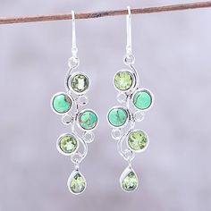 With a green sheen, sparkling peridot gems combine with cabochons of composite turquoise in a pair of dangle earrings from India. Neeru Goel presents the vine-like earrings, crafted of high-polish sterling silver by local artisans. Green Peridot Drop Earrings, Green Peridot Dangle Earrings, Green Gemstone Dangle Earrings, Green Teardrop Gemstone Accents Jewelry, Green Teardrop Gemstone Jewelry, Green Teardrop Jewelry With Gemstone Accents, Green Teardrop Earrings With Gemstone Accents, Green Drop Earrings With Gemstone Accents, Turquoise Dangle Earrings