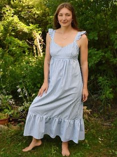 Blue Gingham Check Cotton Empire Waist Maxi Dress This Lovely sleeves less dress has straps with Ruffles, an elegant sweetheart neckline, lined bodice, thinning empire silhouette with smocked backing for extra comfort and hidden pockets  Constructed of calico cotton  Lay flat measurements:  Pit to pit- 18 in  Under bust- 16 in Bodice length from front- 4 in Skirt length with ruffle-  37 in  Skirt width below pockets- 25 in  Best fits small and medium busts  Handcrafted with love  In Hastings MI Gingham Dress With Ruffled Straps For Summer, Picnic Dress With Smocked Back And Ruffled Straps, Gingham Dress With Smocked Bodice For Garden Party, Square Neck Plaid Dress For Garden Party, Plaid Square Neck Dress For Garden Party, Sleeveless Gingham Dress With Tie Straps, Plaid Dresses With Ruffled Straps, Gingham Dress With Smocked Back For Garden Party, Picnic Sundress With Smocked Bodice