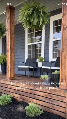 a porch with some chairs and plants on it