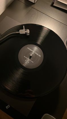 an old record player sitting on top of a table