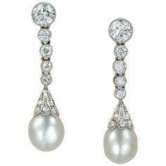 A pair of Edwardian pearl and diamond drop earrings, each earring consisting of a natural drop pearl surmounted from a rose-cut diamond set fluted cap suspended from five graduating old brilliant-cut diamonds, estimated to weigh a total of 1.6 carats, millegrain rub over set in white to a gold mount with post and alpha fittings, circa 1910, measuring 3.4 x 0.8cm, gross weight 5.5 grams. Edwardian earrings in very good. Unmarked tested as Platinum and 18ct Gold. These refined pearl earrings are a Natural Pearl Earrings, Diamonds And Pearls, Diamond Cluster Earrings, Pearl And Diamond Earrings, Natural Pearl, Antique Earrings, Women Diamond, Diamond Drops, Pearl Diamond