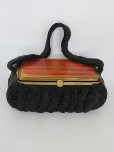 "This listing is for a beautiful small hand bag/purse being sold as-is, final sale. This gorgeous bag was made in the 1950's-60's, and it has a wonderfully unique retro/vintage style; it features an exterior that is beautifully beaded all over, a short strap, and a very interesting silhouette. The bag opens from the top, which is made out of a hard material and has what appears to be the initials \"SG\" on top. The inside of the bag is missing the mirror, see pictures. This bag/purse is in good Vintage Rectangular Evening Bag, Handmade Retro Shoulder Bag For Evening, Handmade Retro Rectangular Evening Bag, Vintage Handheld Evening Bag, Vintage Rectangular Bags For Evening, Vintage Handmade Evening Bag, Vintage Handheld Evening Shoulder Bag, Vintage Beaded Clutch Bag, Handmade Rectangular Retro Evening Bag