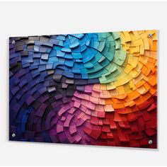 a rainbow colored abstract art piece on a white wall