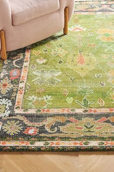 a living room with a couch and rug on the floor