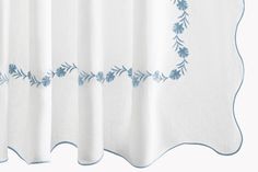 a white curtain with blue flowers on it