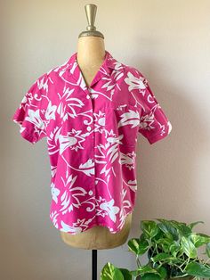 1990s pink Hawaiian style shirt. Pink shirt with white floral pattern. Short sleeve with white buttons, chest pocket. Made of cotton. Would make a good vacation/beach shirt. Shirt is slightly less vibrant in person but still a fun pink. Tag: Forenza Athentic Sportwear  SIZE  Modern size: Medium Bust: 42" Hip: 44" Length: 26" Measurements are taken with the garment lying flat, and un-stretched. Bust, waist and hip measurements are doubled. Sleeves are measured from shoulder seam to cuff. Please remember that these are not body measurements, so leave room for comfort. We suggest that you measure a well-fitting garment to find measurements right for you.  CONDITION  This item is in Good condition. The fabric is faded with some pilling in various spots. There are a couple of very faint spots o Cheap Relaxed Fit Hawaiian Shirt With Floral Print, Cheap Collared Hawaiian Shirt With Floral Print, Affordable Beach Hawaiian Shirt Button-up, Luau Clothes, Luau Outfits, Floral Button Up Shirt, Pink Hawaiian Shirt, Luau Theme, Floral Button Up